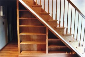 A personalized woodworking staircase with shelves underneath, showcasing a unique and functional design element